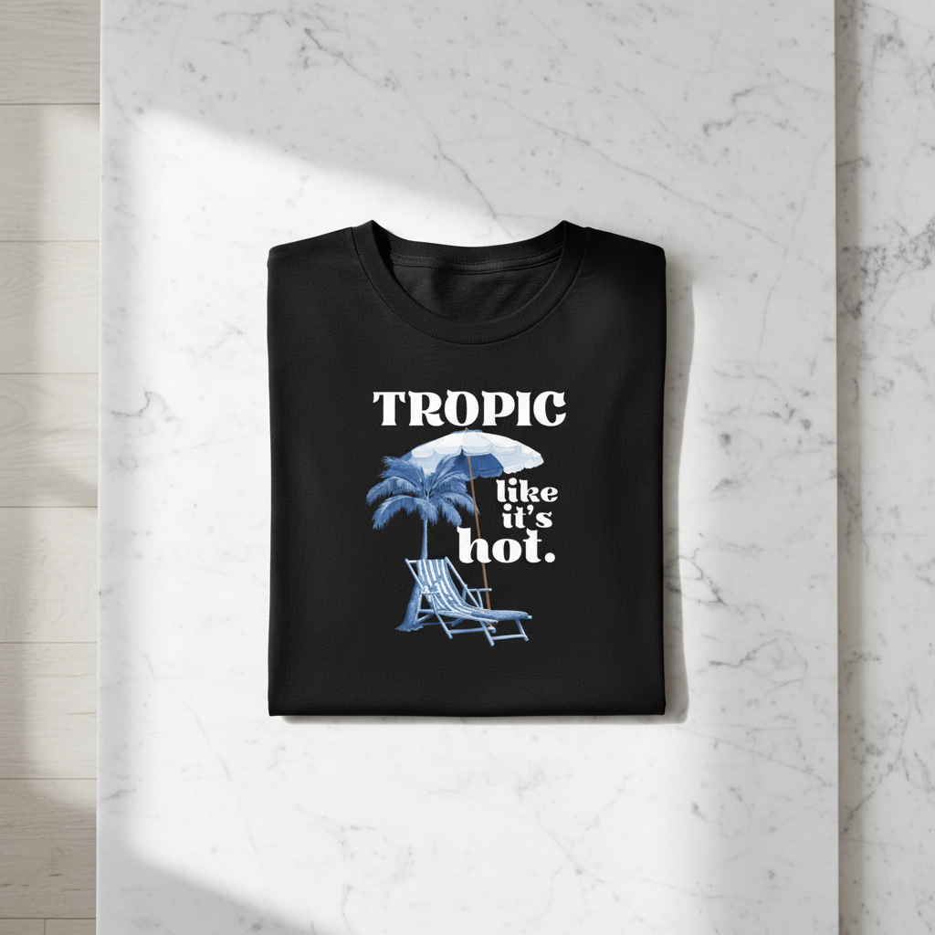 Black tropical graphic T-shirt with palm, umbrella, and “like it’s hot” text print