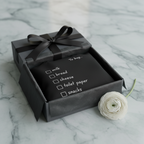 Charcoal tote in a gift box with ribbon; 'to buy' checklist: milk, bread, cheese, snacks.
