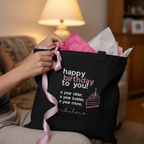 Black cotton tote bag with pink bow ribbon and 'happy birthday to you' wording.