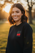 Black crewneck sweatshirt with cherry embroidery patch on left chest.