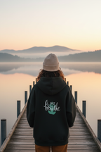 Black mindfulness hoodie with “Just breathe” slogan and hand heart graphic on back