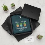 Teal crewneck teacher gift T-shirt with cartoon plants and text 'sticks together'.
