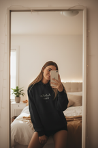 Black hoodie with cursive 'delulu' and 'VIBES' text on front
