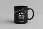 Black ceramic mug with white muffin graphic, red heart, and “to you!” text