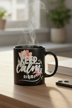 Black coffee mug with floral “Keep Calm” print and curved handle