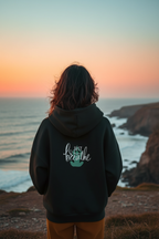 Black mindfulness hoodie with “Just breathe” slogan and hand heart graphic on back