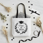 White graduation tote bag with Class of 2026 wreath, mortarboard, and text print