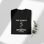 Black T-shirt with "slow progress" slogan and minimal plant graphic, crew neck.