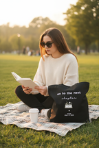 Black tote — reading on grass