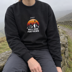 Black Will Hike for Views sweatshirt worn by a stone wall