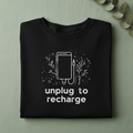 Unisex T-shirt in black with unplug to recharge phone graphic