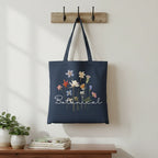 Navy cotton tote bag with dried wildflower artwork and "Botanical" text.