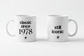 Pair of white ceramic coffee mugs: 'classic since 1978' and 'still iconic'