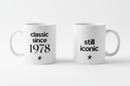 Set of two white ceramic coffee mugs with 'classic since 1978' and 'still iconic'