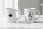 White ceramic birthday mug with crown icon and '50 years to look this good' print