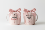 Two 11oz ceramic mugs with pink bows and “birthday queen” prints on sides