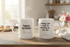 Two white ceramic mugs: one “happy birthday” Sarah, one “wishing you a day…“