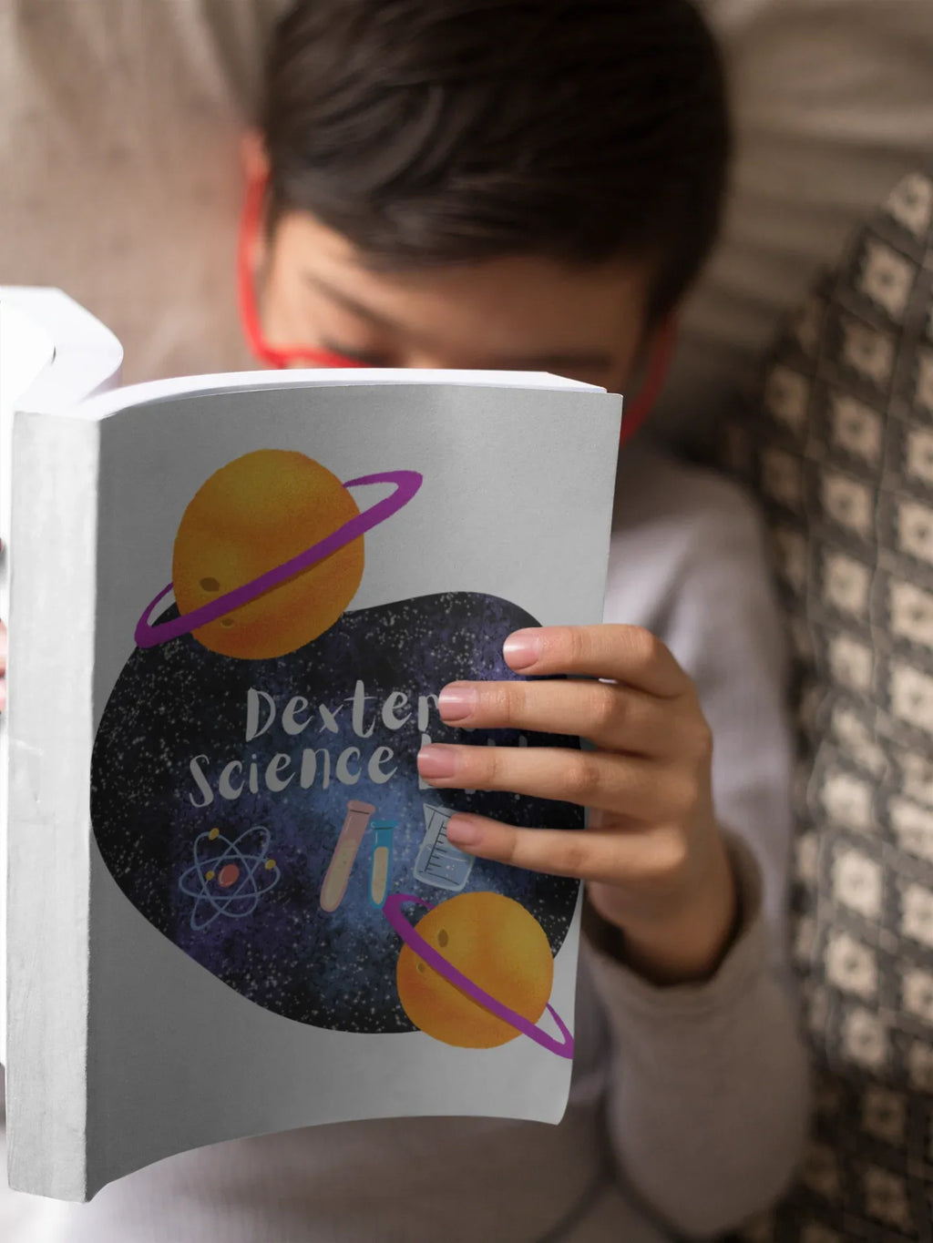 Close-up of science-themed journal cover with planets and purple lettering