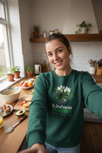 Green crewneck sweatshirt with tree graphic and 'Kindness Matters' print on front