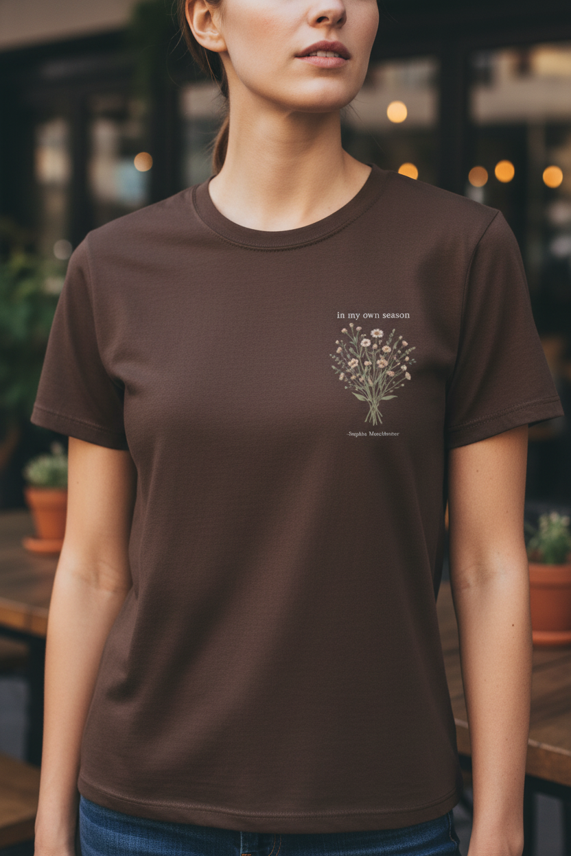 Dark brown T-shirt with small botanical bouquet graphic and centered text