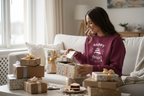 Maroon sweatshirt with “Happy Birthday Joanie” cake graphic worn by a woman