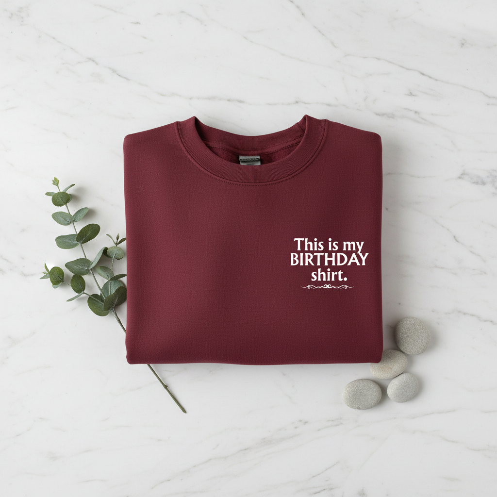 Burgundy crewneck birthday shirt with “This is my BIRTHDAY shirt” print.
