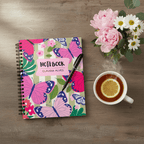 Butterfly spiral notebook with pink name label reading “NOTEBOOK” and “CLAUDIA ALVES”