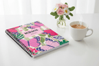Butterfly spiral notebook with pink name label reading “NOTEBOOK” and “CLAUDIA ALVES”