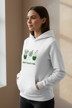 White pullover hoodie with cactus graphic and “don’t touch me.” text on the chest