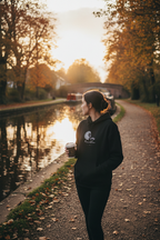 Black unisex hoodie with lion graphic logo, side view with hood up