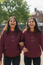 Maroon hoodies with drawstring hoods and small chest slogan print