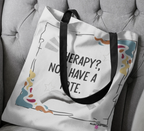 White tote bag on sofa cushion with black handles and printed quote plus doodles.