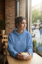 Carolina blue hoodie with hood and “delulu VIBES” front print, kangaroo pocket