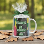Wrapped white gift mug with green “Introverted” and “Outdoorsy” text graphic.
