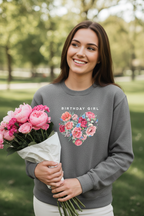 Gray crewneck sweatshirt with “Birthday Girl” text and pink floral heart graphic on chest