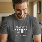 Gray dad T-shirt with 'I'M A PROUD FATHER' graphic and names FINN • BELLE • RORY