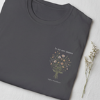 Dark gray T-shirt with small botanical bouquet graphic and signature text