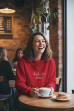 Cherry red hoodie with hood, kangaroo pocket, and “delulu VIBES” front print