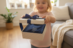 Navy T-shirt visible inside a blue gift box with ribbon