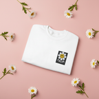 White sweatshirt with embroidered flower smile patch reading CHLOE on the chest