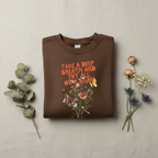 Dark brown crewneck sweatshirt with colorful “Take a Deep Breath” floral graphic on front.