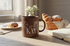 Brown ceramic mug with floral line art and the name “KAY” printed on the front.