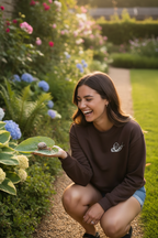 Brown crewneck sweatshirt with a white snail graphic on the chest