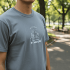 Blue T-shirt with small white mountain and tree graphic and 'BY NATURE' text