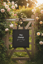 Black canvas tote bag with handles and “The Clarke family” text and heart
