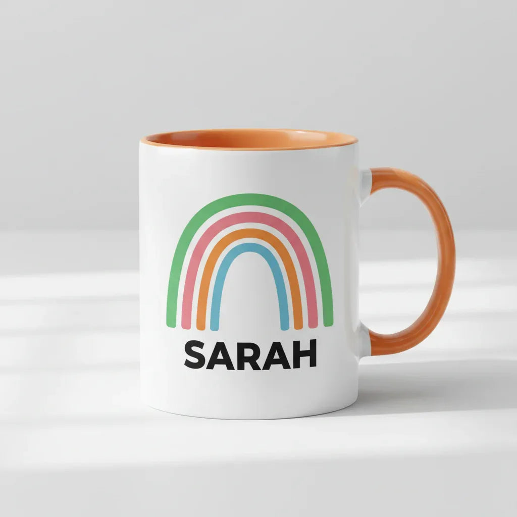 Personalised rainbow mug with name SARAH, orange handle and orange inner rim.