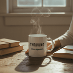 White ceramic mug with “THRIVING (Term dependant)” and visible steam from the cup.