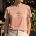 Mauve crew-neck T-shirt with “GOOD ENERGY ONLY” graphic centered on the chest