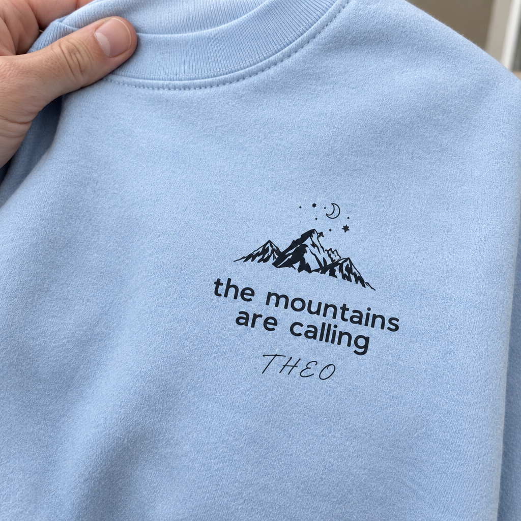 Close-up light-blue Mountains Are Calling sweatshirt with Theo