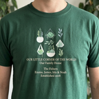 Forest green botanical t-shirt with potted plant graphic and “Our Family Home” text